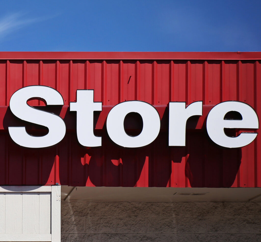 background of a thrift store front sign in the summer time toned